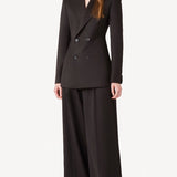 Front view of brown l/s wool double breast tuxedo jacket on model wearing brown pants, against a white background.