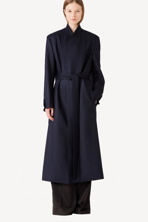 Alternate front view of navy l/s wool lauren trench coat on model wearing black pants, against a white background.