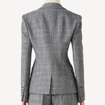 Back view of grigio fantasia wool petit blazer on model wearing grigio pants, against a white background.
