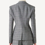 Back view of grigio fantasia wool petit blazer on model wearing grigio pants, against a white background.