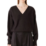 Front view of brown lavinia sweater on model wearing brown pants, against a white background