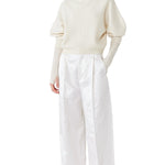 Front view of ivory mina cashmere bat wing sweater on model wearing white pants, against a white background.