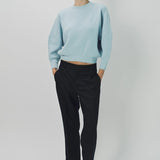 Front view of cielo mina cashmere bat wing sweater on model wearing black pants and flats, against a white background.