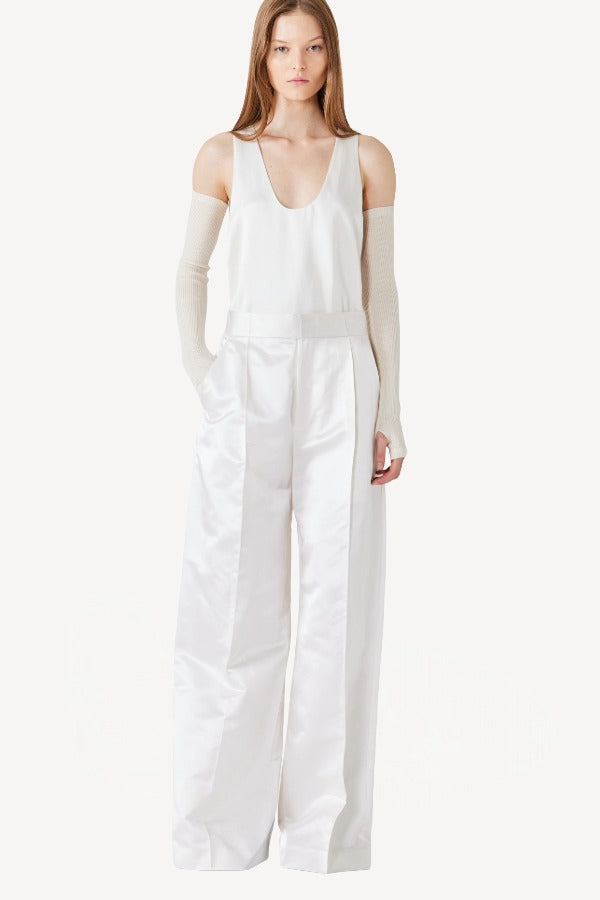 Front view of ivory S/L Silk/Viscose Tank Top on model wearing white pants, against a white background.