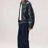Side view of black ant de padovane jacket on model wearing white shirt, jeans and boots, against a white background.