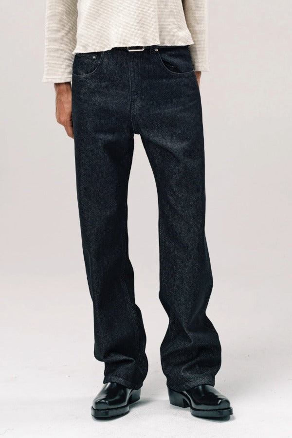 Front view of black big papi denim on model wearing white shirt and boots, against a white background.