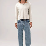 Alternate front view of stone wash big papi denim pants on model wearing white shirt and boots, against a white background.