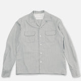 Grey Speckle Church Shirt laying on flat surface, against white background.