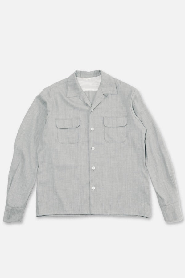 Grey Speckle Church Shirt laying on flat surface, against white background.