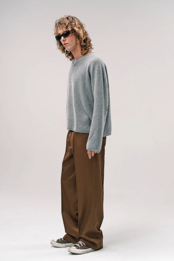 Alternate side view of dove grey friends pullover sweater on model wearing brown pants and sneakers, against a white background.