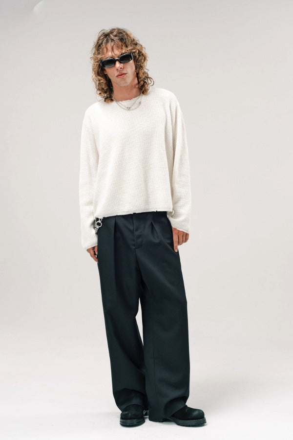 Alternate front view of blanc friends pullover sweater on model wearing grey pants and boots, against a white background.