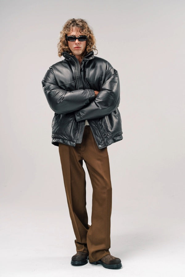 Alternate front view of brown leather puffa jacket on model wearing white shirt and brown pants with boots, against a white background.