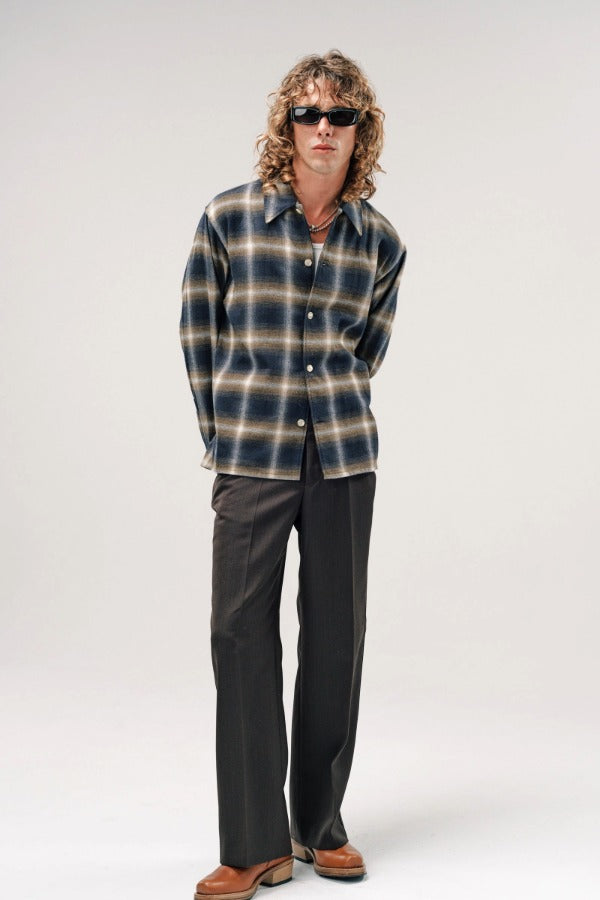 Alternate front view of olive check logan ombre ls shirt on model wearing white shirt, grey pants and boots, against a white background.