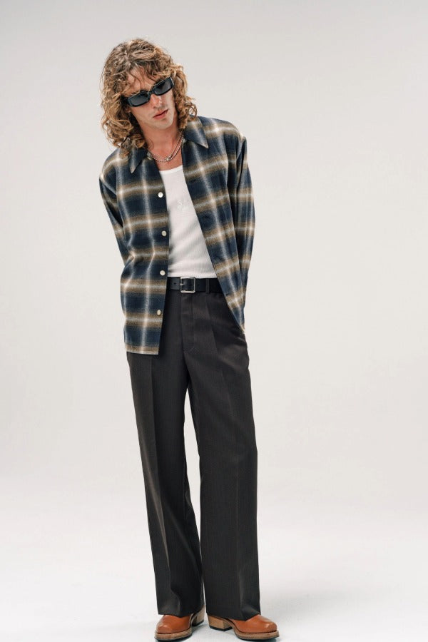 Alternate front view of olive check logan ombre s shirt on model wearing white shirt, grey pants and boots, against a white background.