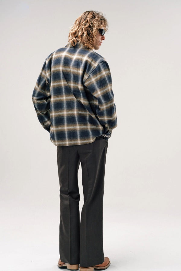 Back view of olive check logan ombre ls shirt on model wearing grey pants and boots, against a white background.