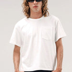 Front view of vintage white slappy pocket tee on model wearing jeans, against a white background.