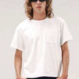 Front view of vintage white slappy pocket tee on model wearing jeans, against a white background.