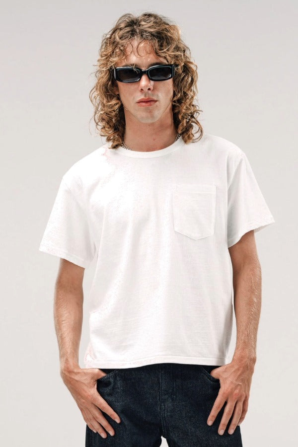 Front view of vintage white slappy pocket tee on model wearing jeans, against a white background.