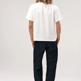 Back view of vintage white slappy pocket tee on model wearing jeans and boots, against a white background.