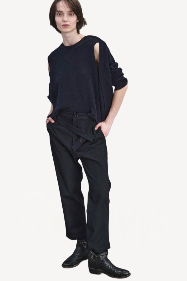 Front view of titan midnight assk pants on model wearing navy top and boots, against a white background.