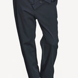 Front closeup view of titan midnight assk pants on model wearing navy top and boots, against a white background.