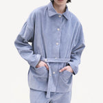 Front view of blue ice work jacket on model wearing blue ice pants, against a white background.