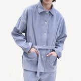 Front view of blue ice work jacket on model wearing blue ice pants, against a white background.
