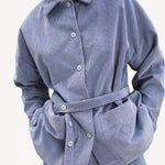 Front closeup view of blue ice work jacket on model wearing blue ice pants, against a white background.