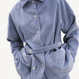 Front closeup view of blue ice work jacket on model wearing blue ice pants, against a white background.