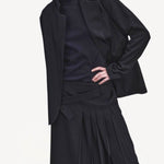 Front closeup view of titan midnight cate jacket on model wearing black kilt and boots, against a white background.