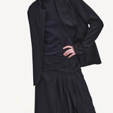 Front closeup view of titan midnight cate jacket on model wearing black kilt and boots, against a white background.