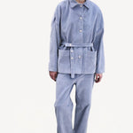 Front view of blue ice esra marine pants on model wearing blue ice jacket and boots, against a white background