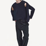 Front view of navy jakeset sweater on model wearing black pants and boots, against a white background.