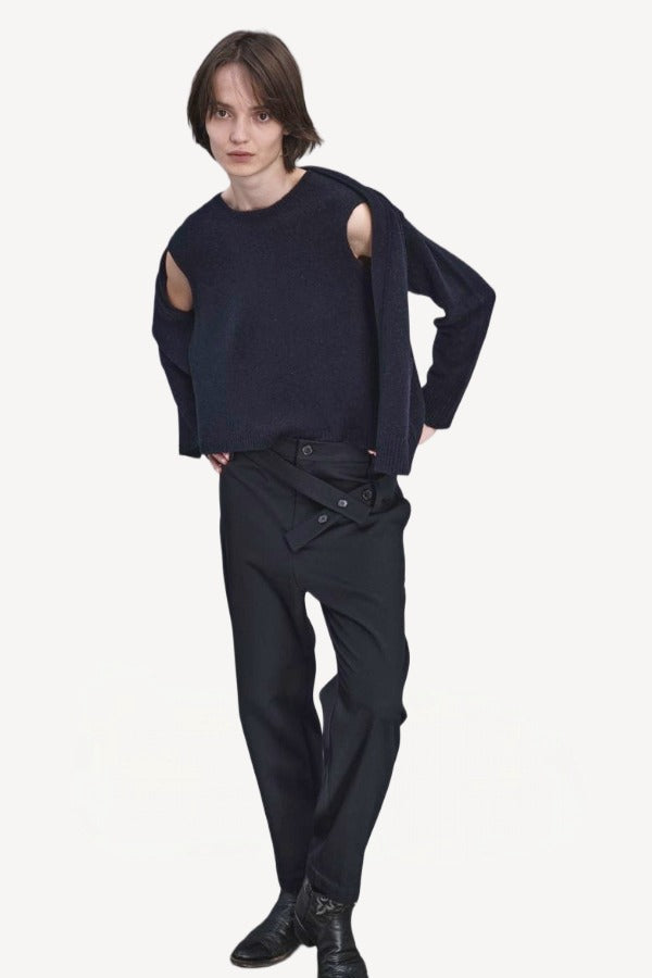 Front view of navy jakeset sweater on model wearing black pants and boots, against a white background.