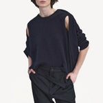 Front closeup view of navy jakeset sweater on model wearing black pants, against a white background.