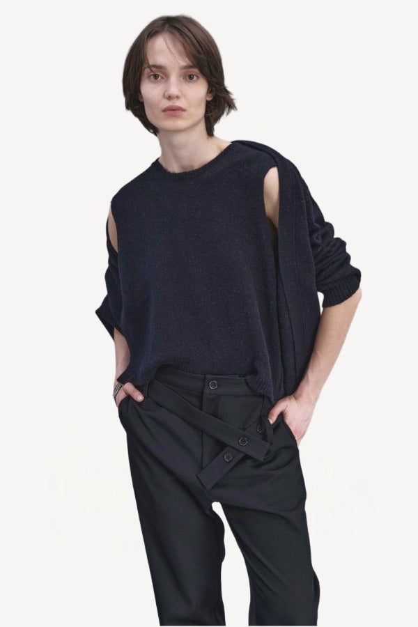 Front closeup view of navy jakeset sweater on model wearing black pants, against a white background.