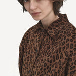 Front closeup view of leopard work jacket on model, against a white background.