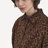 Front closeup view of leopard work jacket on model, against a white background.