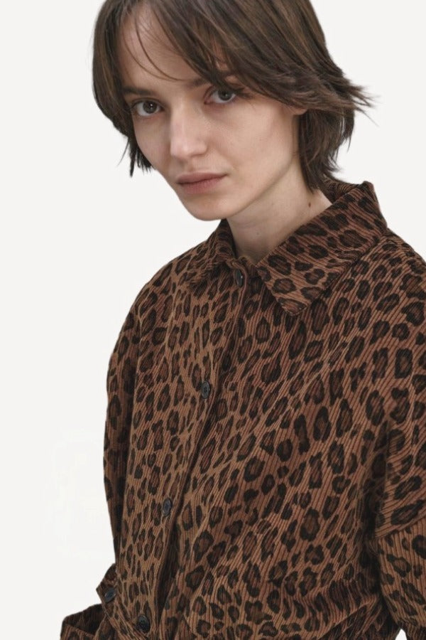 Front closeup view of leopard work jacket on model, against a white background.