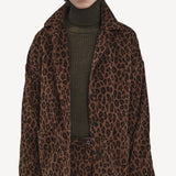 Alternate front view of leopard work jacket on model wearing green sweater and leopard pants, against a white background.