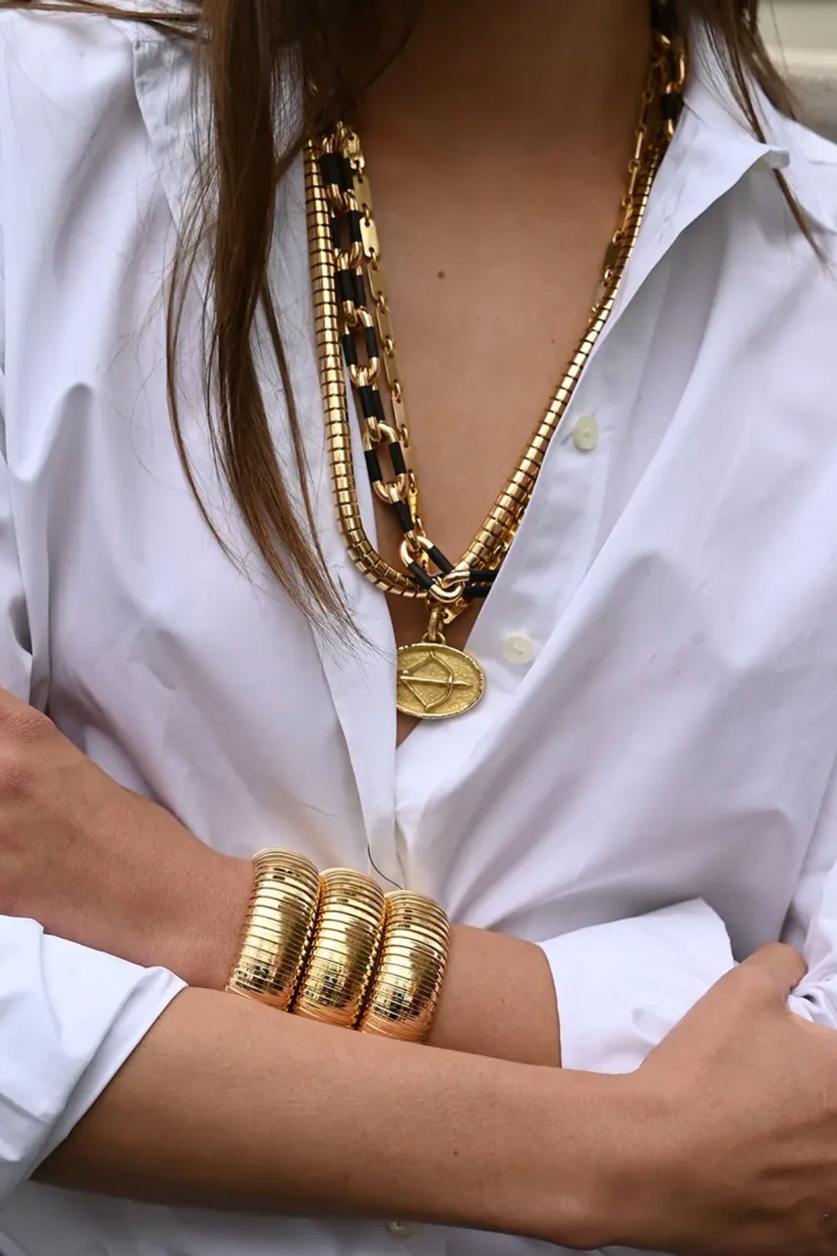 18K YG and Black Ebony Link Necklace on white background, with model wearing a white shirt and the necklace combined with other tubular necklaces and bracelets
