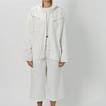 Front view of snow buck ls shirt on model wearing white shirt and pants, against a white background.