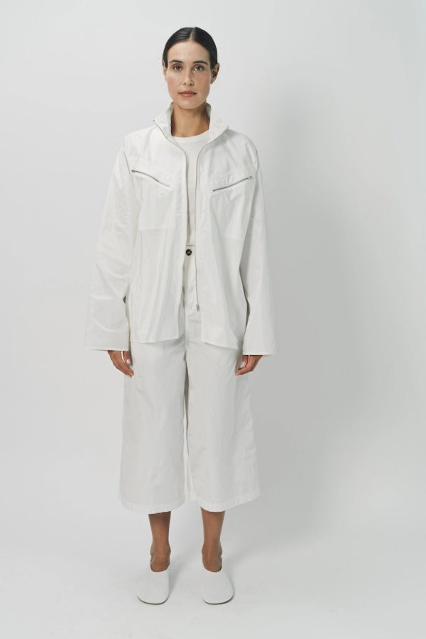 Front view of snow buck ls shirt on model wearing white shirt and pants, against a white background.
