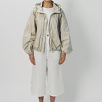 Front view of desert colima zip up hoodie on model wearing white shirt and pants, against a white background