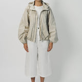 Front view of desert colima zip up hoodie on model wearing white shirt and pants, against a white background