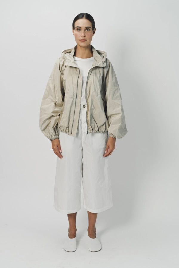 Front view of desert colima zip up hoodie on model wearing white shirt and pants, against a white background