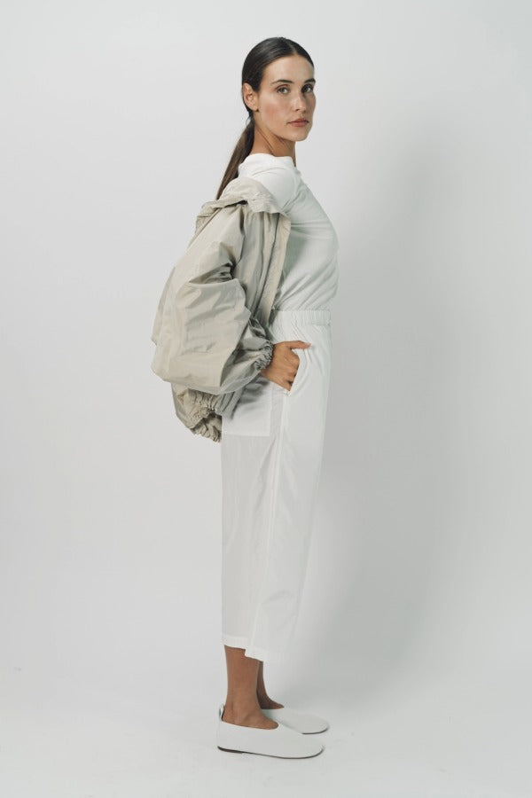 Alternate Side view of desert colima zip up hoodie on model wearing white shirt and pants against a white background.