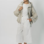 Alternate front view of desert colima zip up hoodie on model wearing white shirt and pants, against a white background