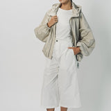 Alternate front view of desert colima zip up hoodie on model wearing white shirt and pants, against a white background