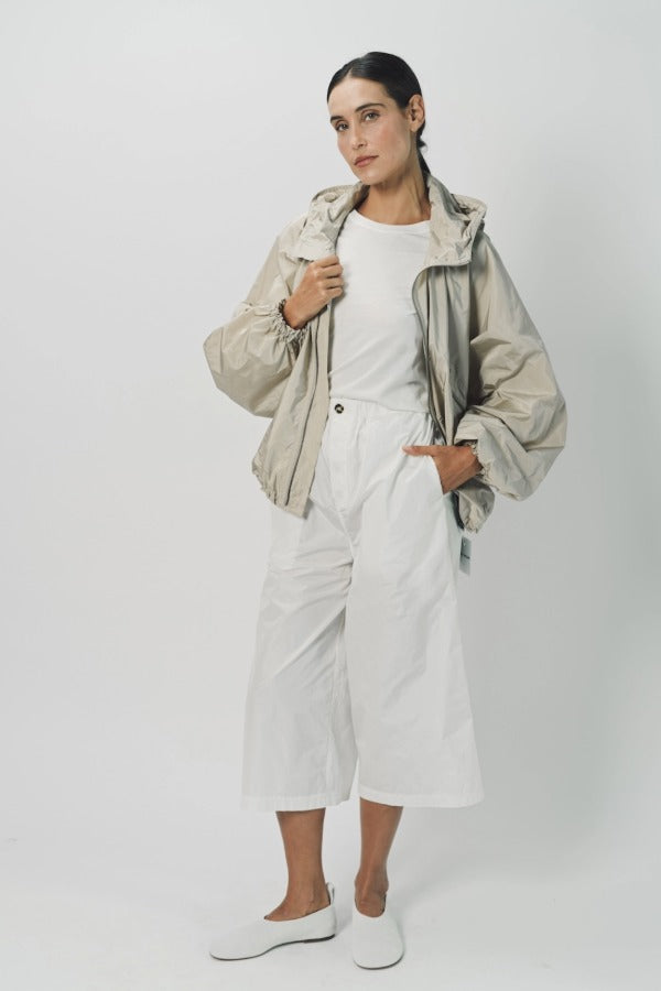 Alternate front view of desert colima zip up hoodie on model wearing white shirt and pants, against a white background